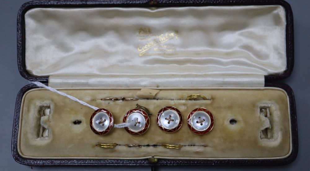 Four early 20th century cased 9ct, mother of pearl and enamel buttons.